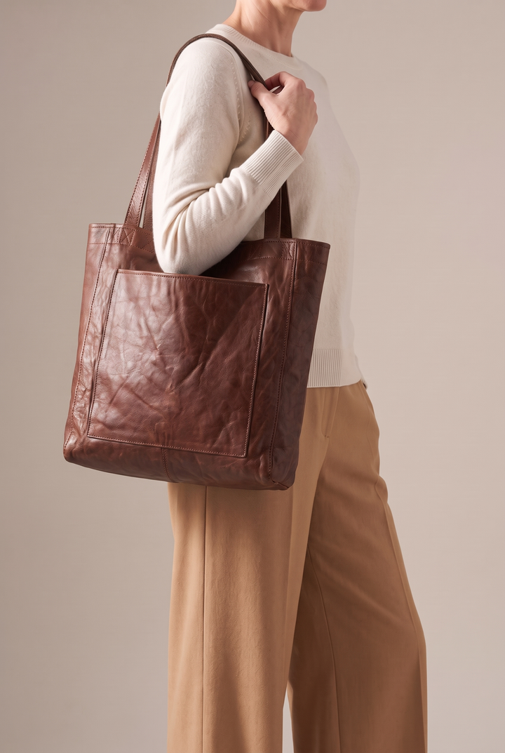 Marlowe large faux leather tote in brown - worn on the shoulder