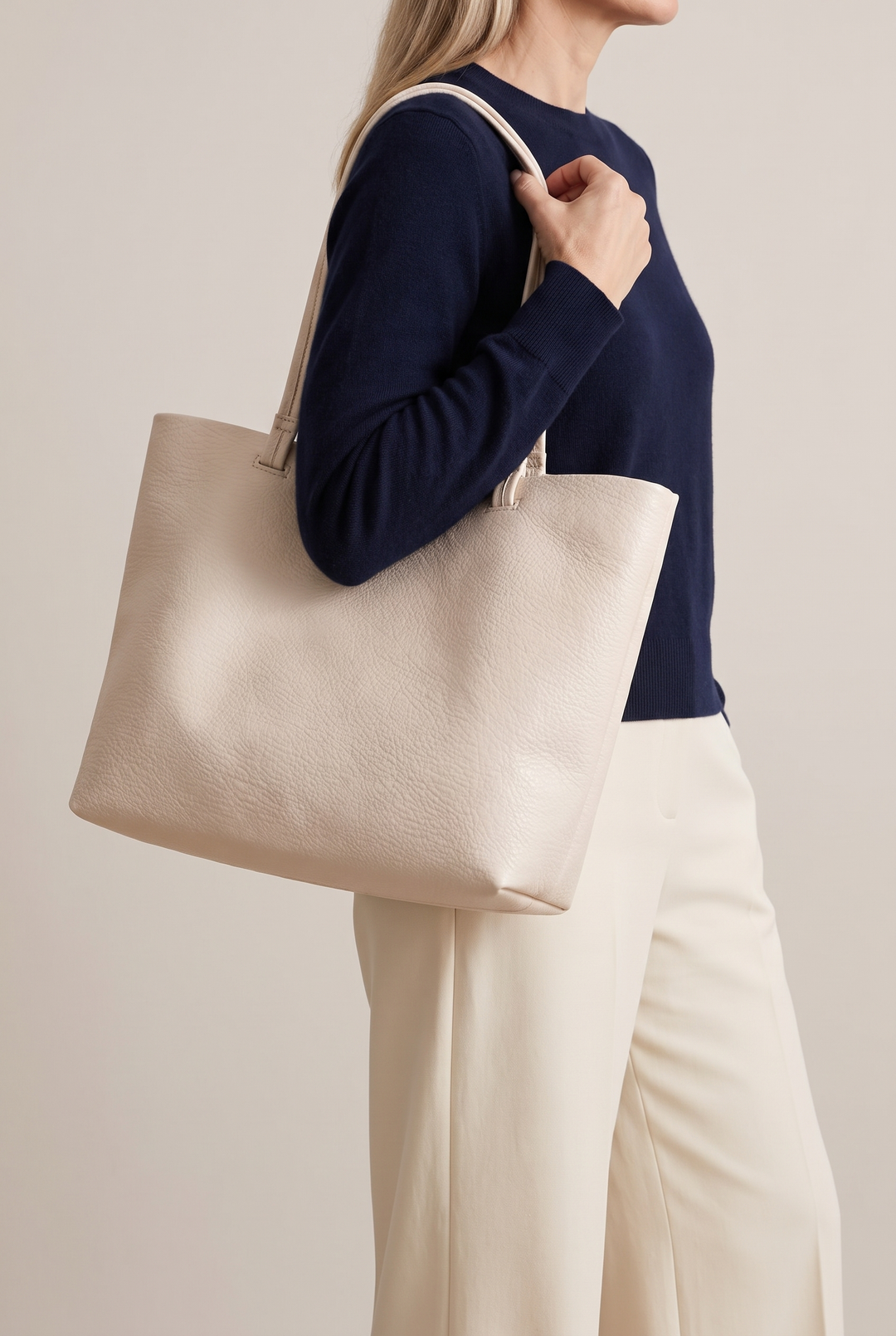Reyna minimalist tote in beige - worn on the shoulder
