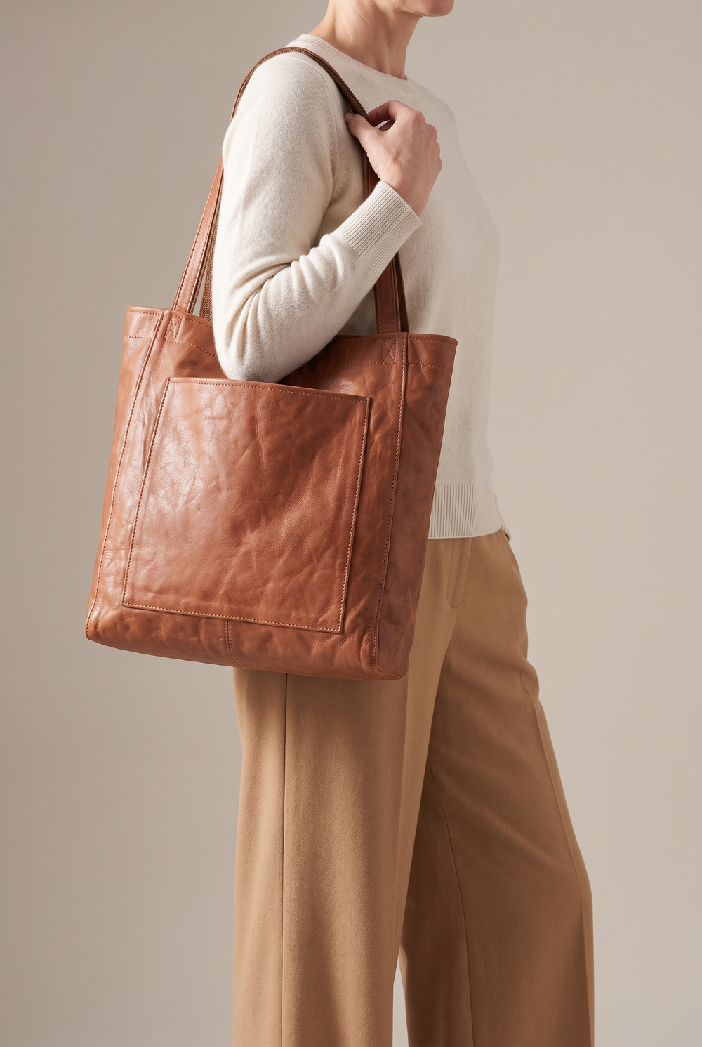 Marlowe large faux leather tote in light brown - worn on the shoulder