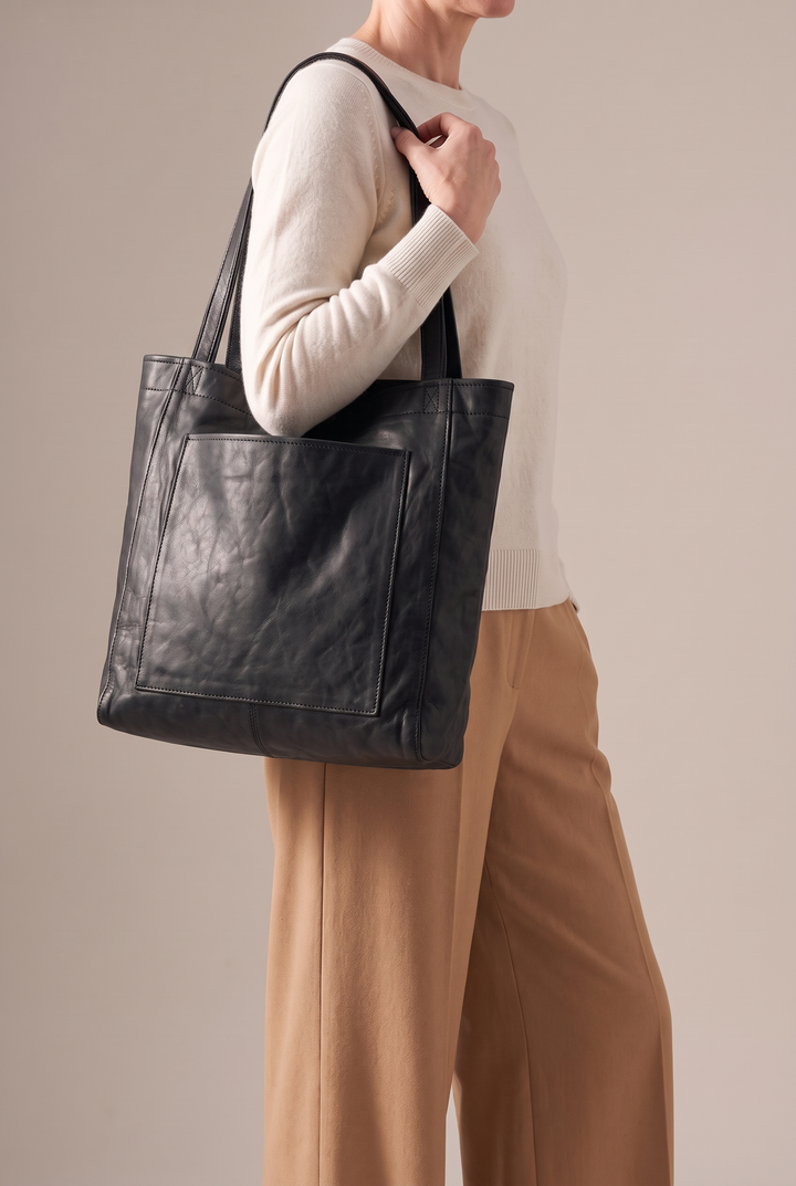 Marlowe large faux leather tote in black - worn on the shoulder